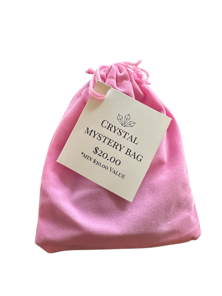 Kelowna Crystal Cave - Pink drawstring bag with a 'Crystal Mystery Bag' tag on a white background