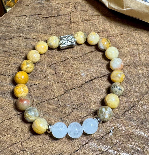 My Two Daughters Jewelry - A bracelet made of round beads with varying shades of white, beige, brown, and gray, featuring a silver-colored clasp.