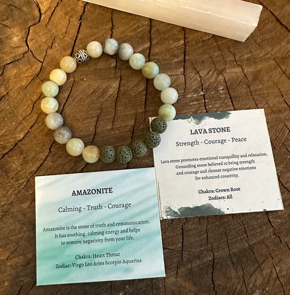 My Two Daughters Jewelry - An essential oil bracelet with beads, made of amazonite and lava stone, displayed on a wooden surface with cards describing the properties of each stone.