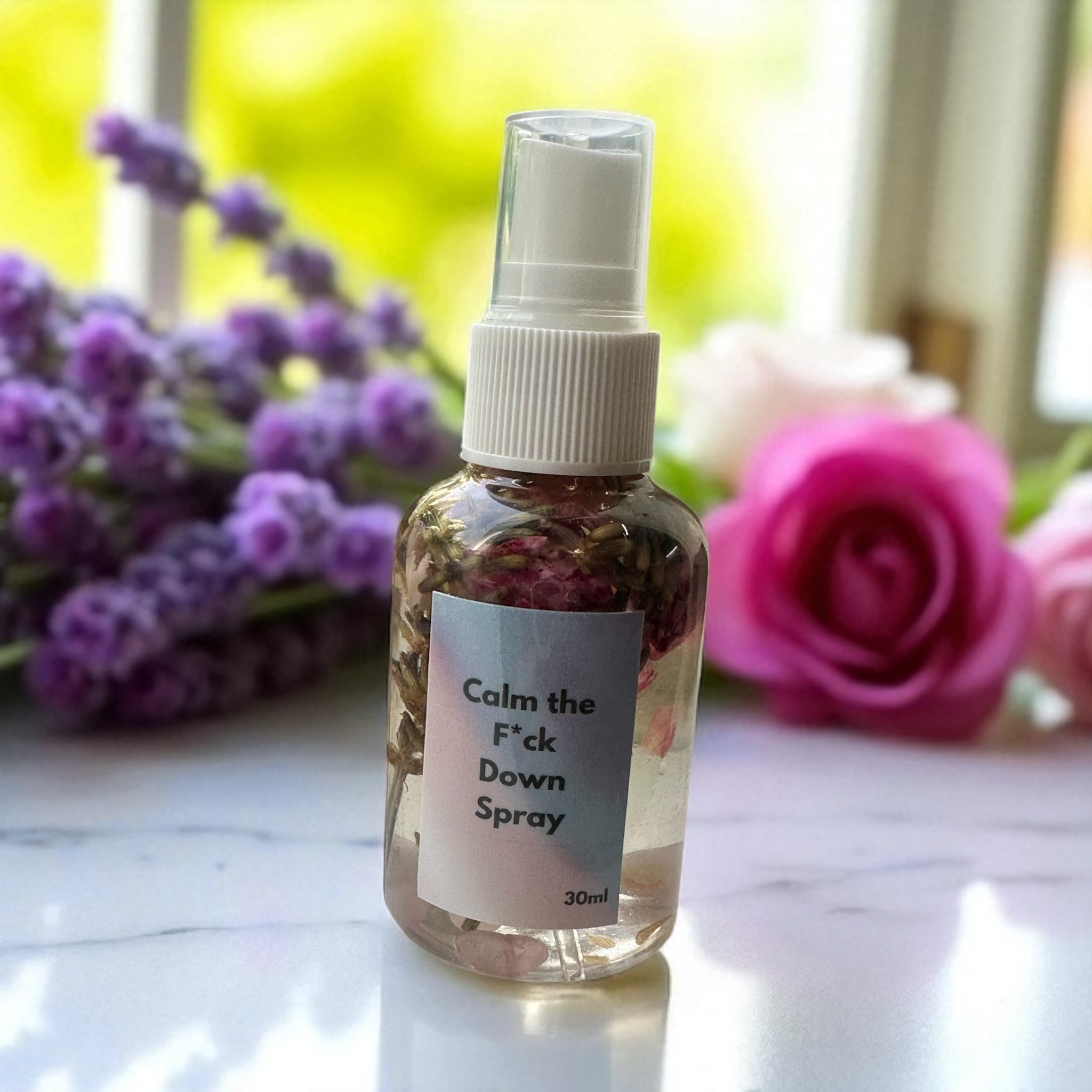 Blazin Creationz - Spray bottle labeled 'Calm the F*ck Down Spray' with flowers in the background