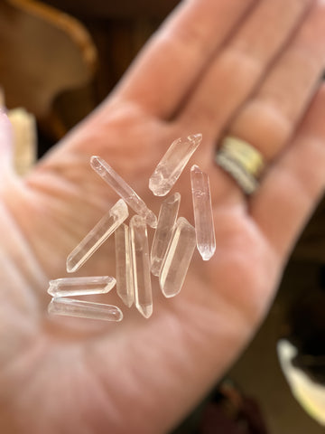 Kelowna Crystal Cave - Clear crystal points held in a hand with a blurred background