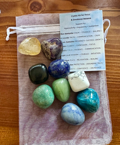 Kelowna Crystal Cave - Crystal kit for focus and emotional balance with stones and a card on a wooden surface