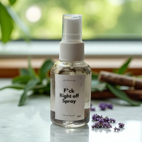 Blazin Creationz - Spray bottle labeled 'F*ck Right off Spray' on a surface with plants in the background