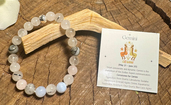 My Two Daughters Jewelry - Gemstone bracelet on a wooden surface with a card about Gemini zodiac sign