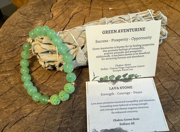My Two Daughters Jewelry - A photo of a green aventurine and lava stone essential oil bracelet displayed alongside its packaging which includes information cards about the stones' properties.