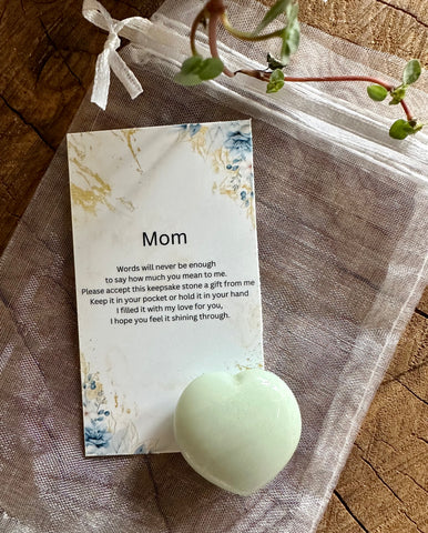 Kelowna Crystal Cave - A note with the word 'Mom' on it, inside an organza bag, accompanied by a 30mm heart-shaped crystal.