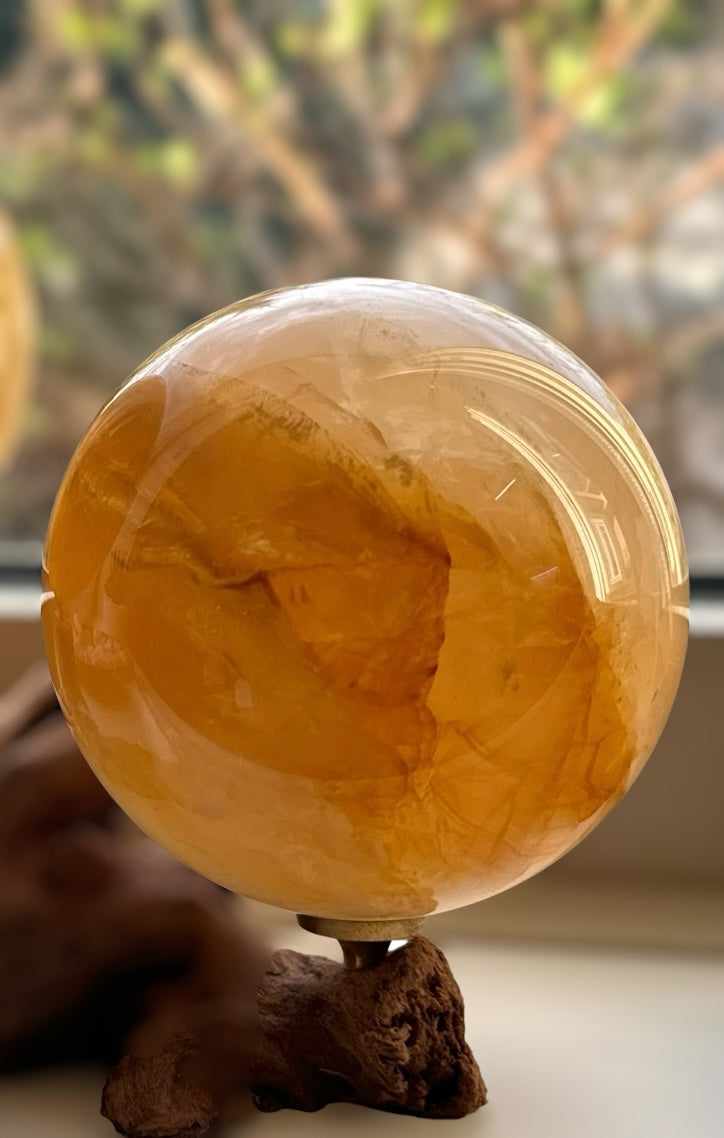 Kelowna Crystal Cave - Golden healer sphere on wooden stand