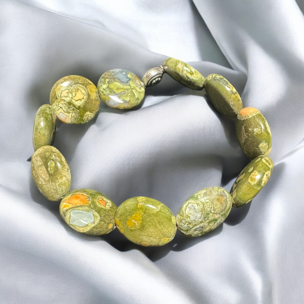 My Two Daughters Jewelry - A bracelet made of rhyolite stones, displayed on a silky gray background.