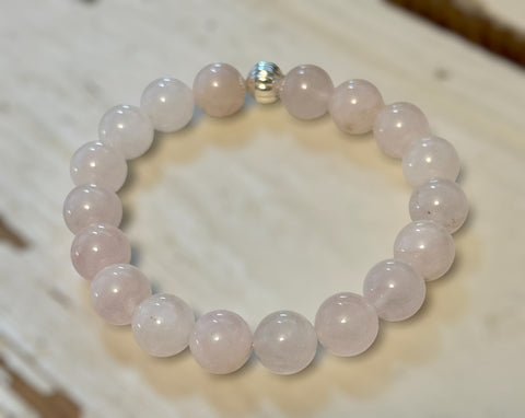 My Two Daughters Jewelry - Rose quartz beaded bracelet on a wooden surface
