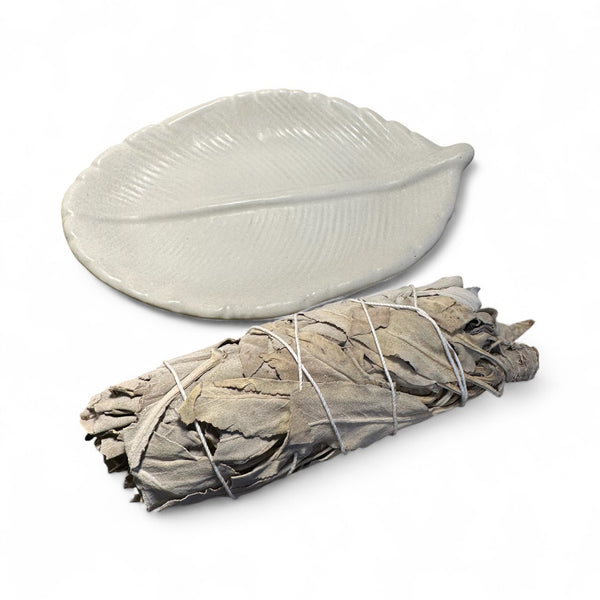 TRUE ART KELOWNA - Bundled sage with a leaf-shaped cement holder on a white background