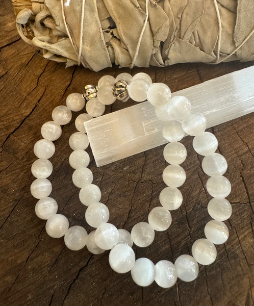 My Two Daughters Jewelry - A white selenite bracelet with beaded design, displayed on a wooden surface.