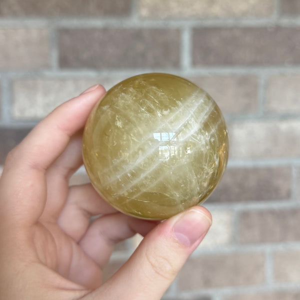 Kelowna Crystal Cave - Small Citrine Sphere in Hand