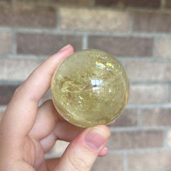 Kelowna Crystal Cave - Small Sized Citrine Sphere in Hand