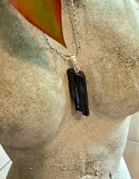 My Two Daughters Jewelry - Tourmaline necklace on silver chain resting on a concrete bust