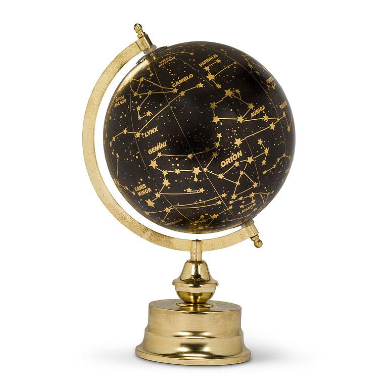 TRUE ART KELOWNA - A globe with constellations demarcated in gold on a black surface, mounted on a golden stand with a latitude finder.
