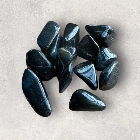 Kelowna Crystal Cave - A collection of polished blue tiger's eye stones with a smooth surface.