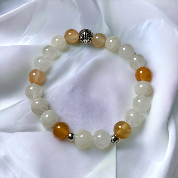 My Two Daughters Jewelry - A bracelet with polished carnelian and white jade beads, featuring a silver-colored clasp, displayed on a white fabric surface.
