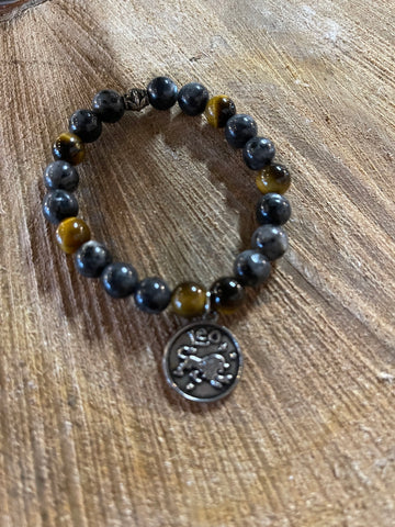 My Two Daughters Jewelry - A bracelet with black and gold colored beads, featuring a Leo zodiac symbol charm.